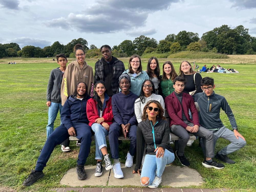 Group of students and faculty sitting on grass. Laf in London Fall 2022